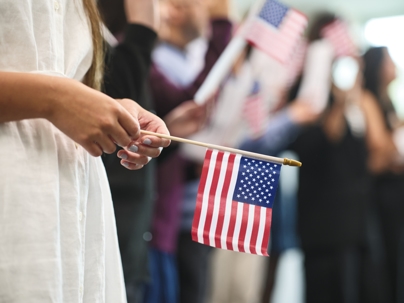immigrant holding American flag